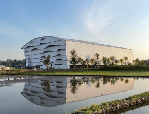 Bali Padel Academy iconic curved-roof architecture reflected in rice paddies