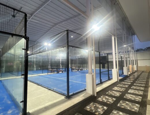 Floodlit glass-walled padel courts at Flamingo Padel Bali, Uluwatu