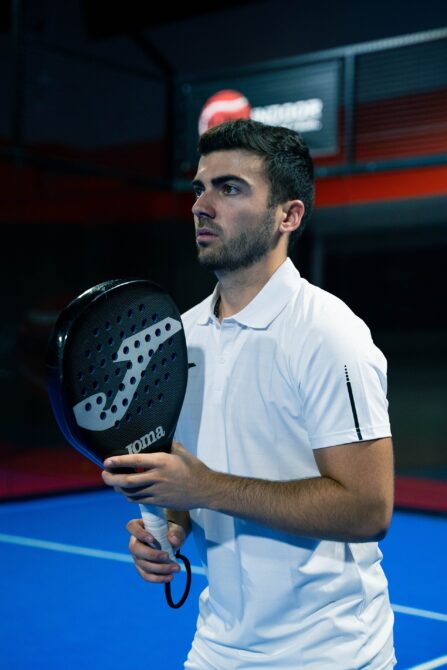 Professional padel coach Nacho Vila holding a racket - the FIP Academy ladder and a strong playing base are the two pillars of becoming a padel coach