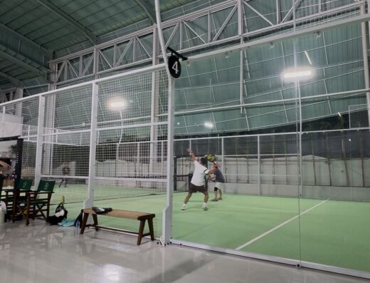 Players rallying on an indoor padel court at Tamora Padel Club Canggu