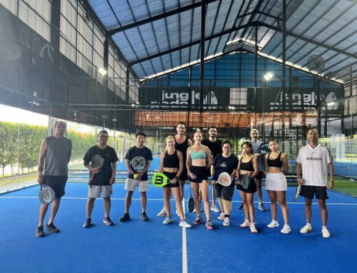 Players with rackets on the blue padel court at Jungle Padel Kerobokan