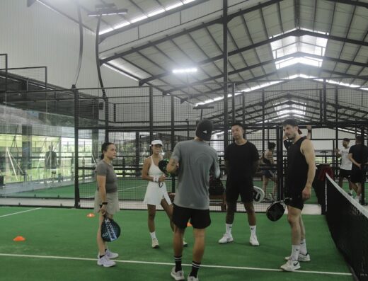 Players in a coaching session on an indoor padel court at Monster Padel Bali