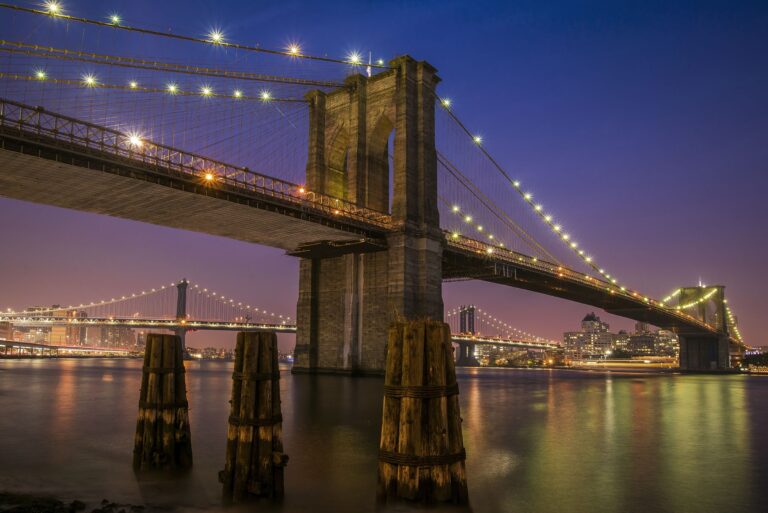 Brooklyn Bridge at dusk with the Manhattan skyline behind